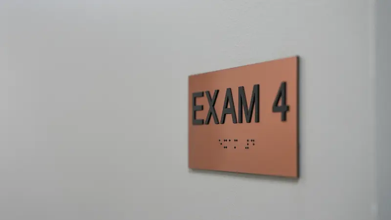 Exam room 4 signage with braille