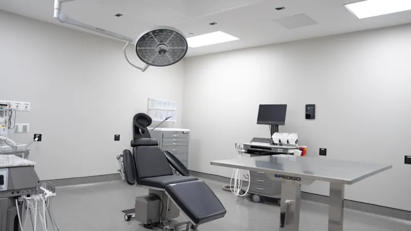Surgical suite with patient chair and overhead surgical light